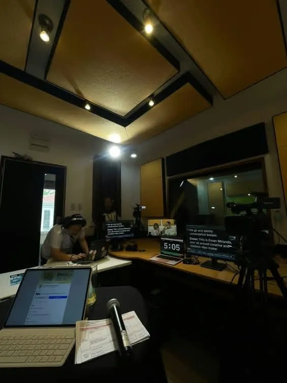 The radio studio’s control room, monitors and a timer lit before the broadcast.