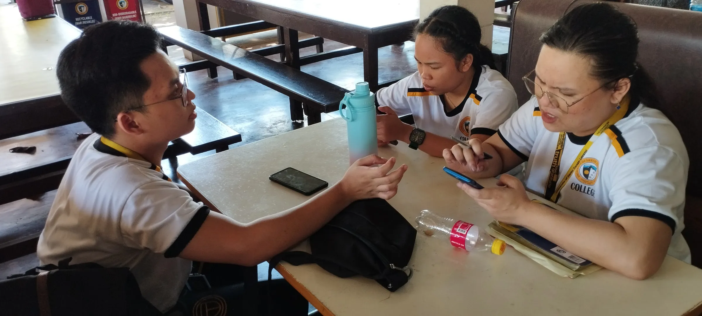 Students at a canteen table planning the radio magazine.
