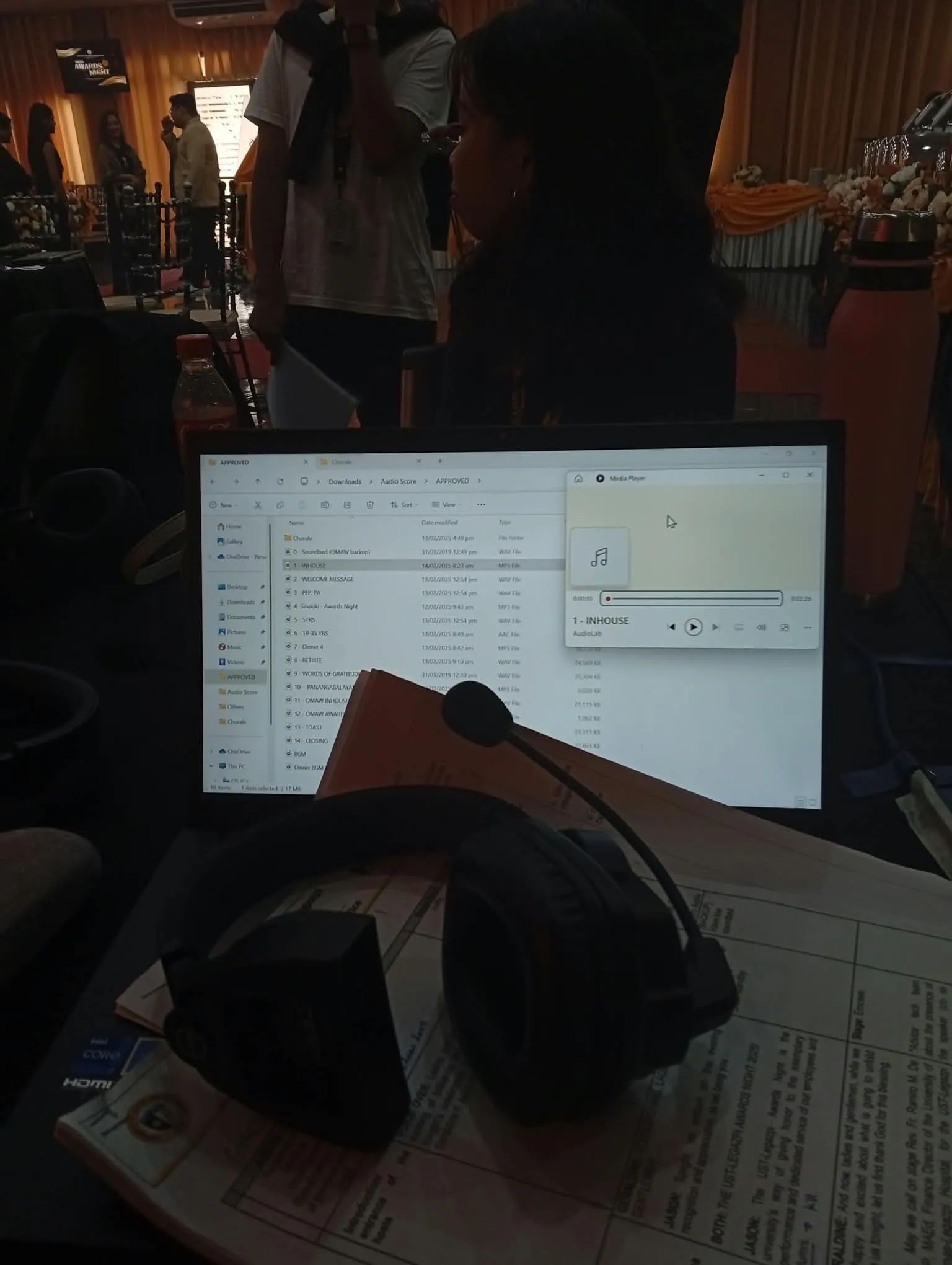 A laptop and a headset on the production desk before the show.