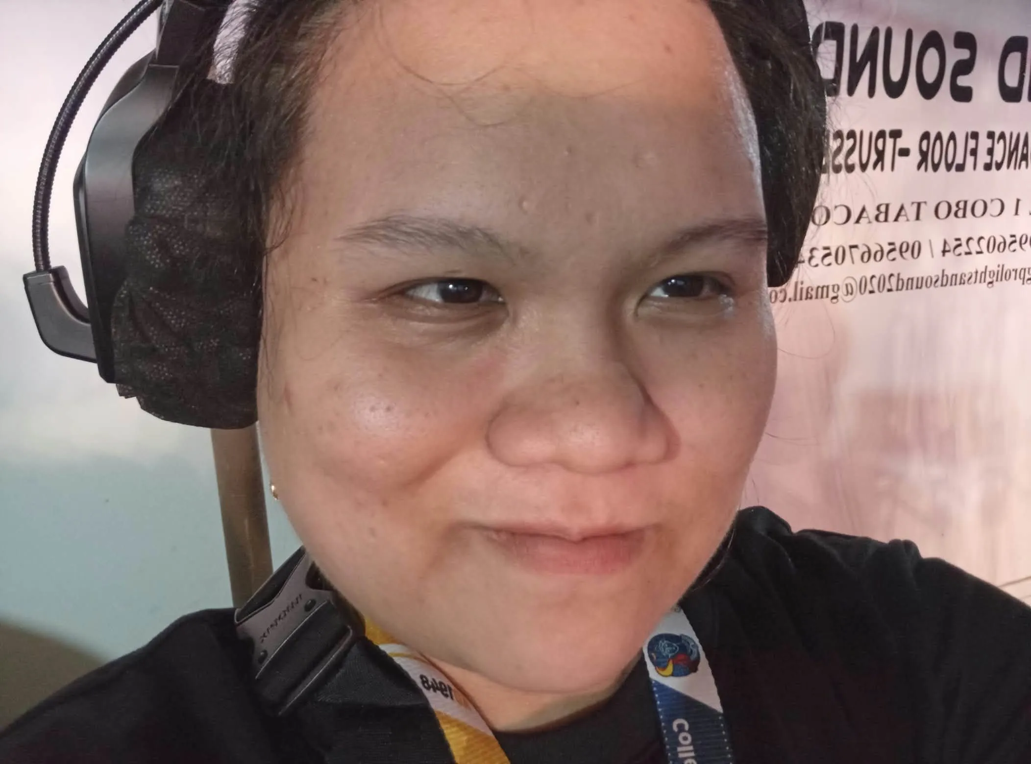 A close-up selfie of a crew member in headphones.