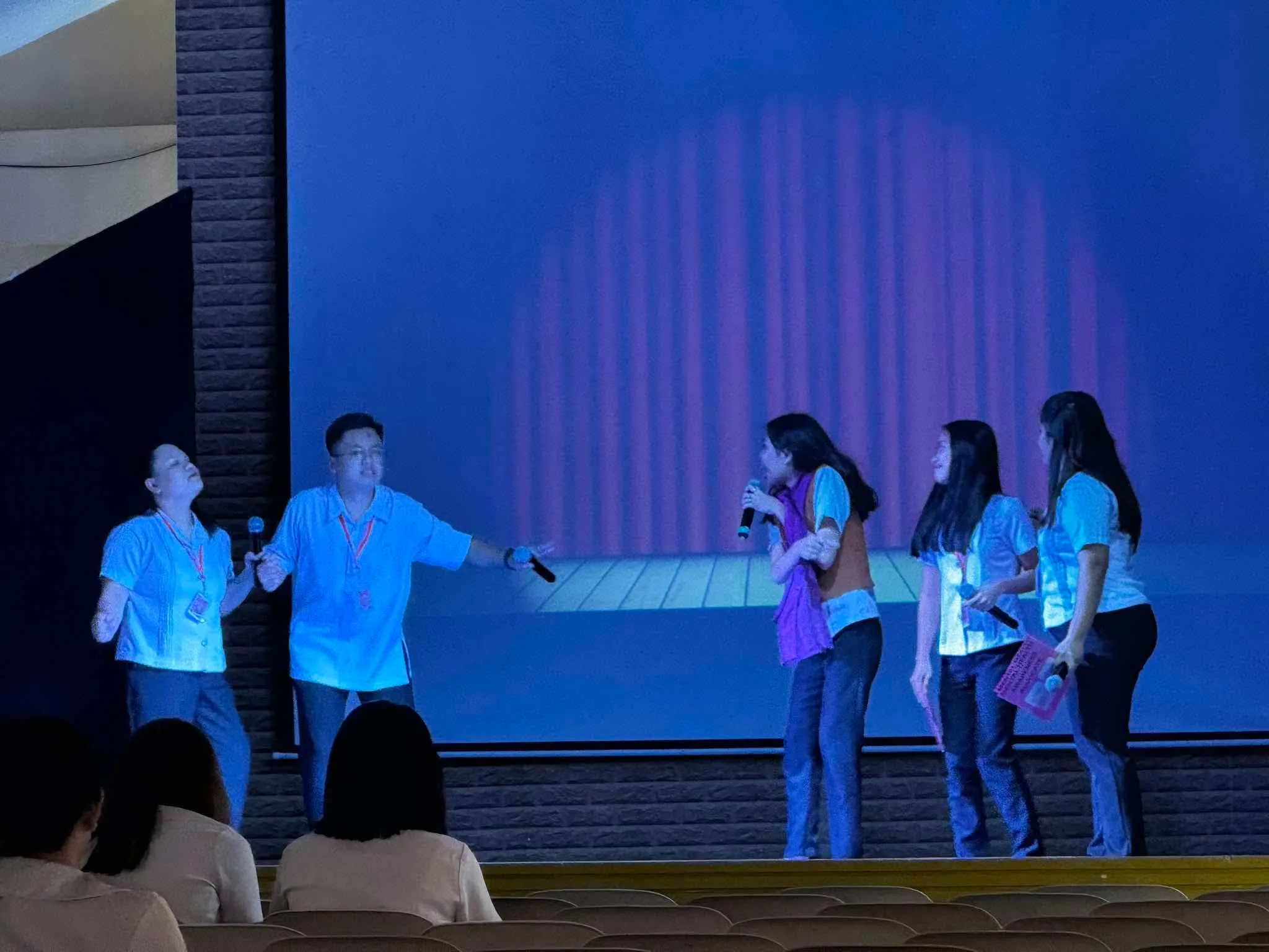 The cast in a line across the stage.