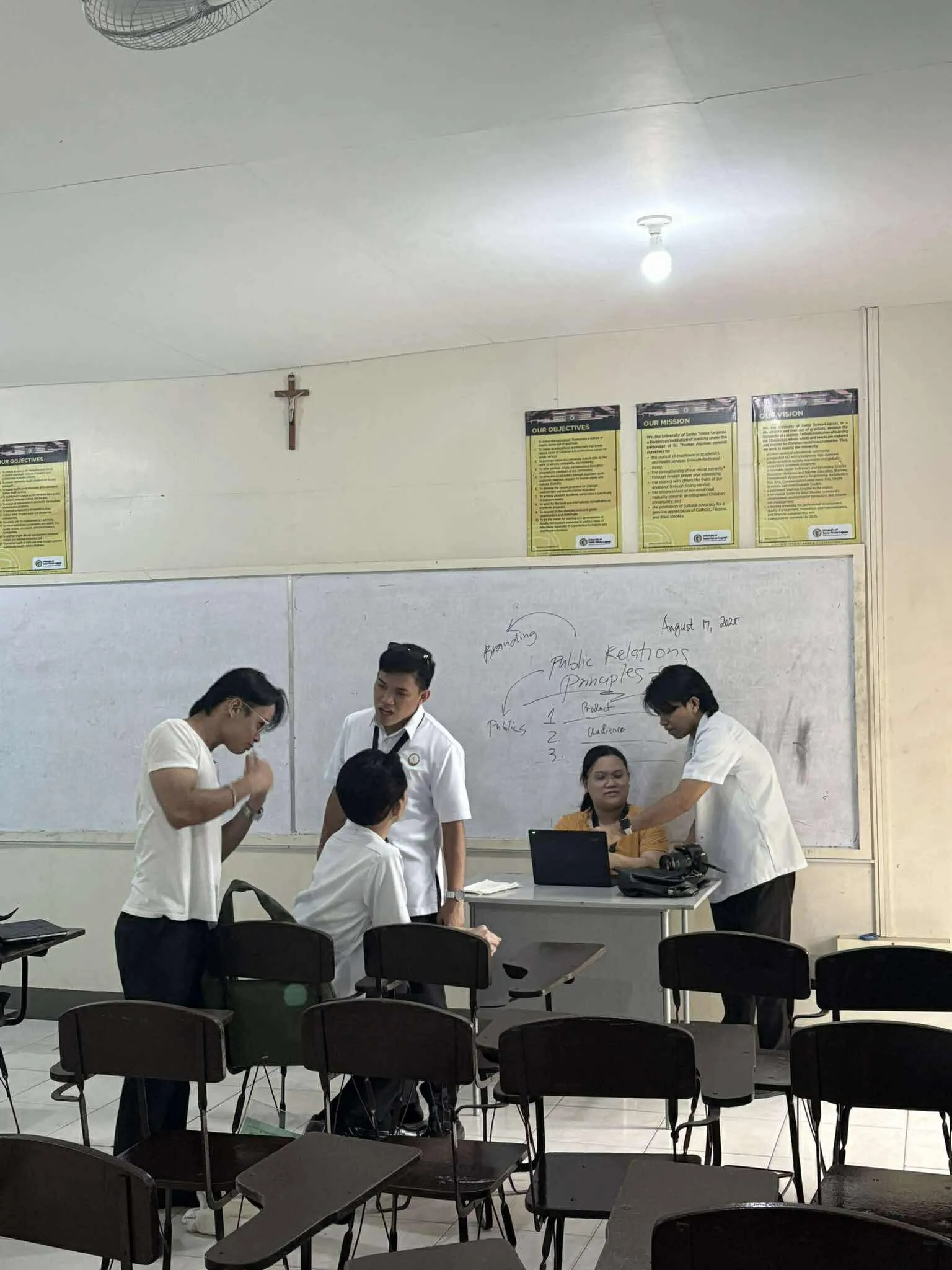 The crew filming a scene in a classroom.