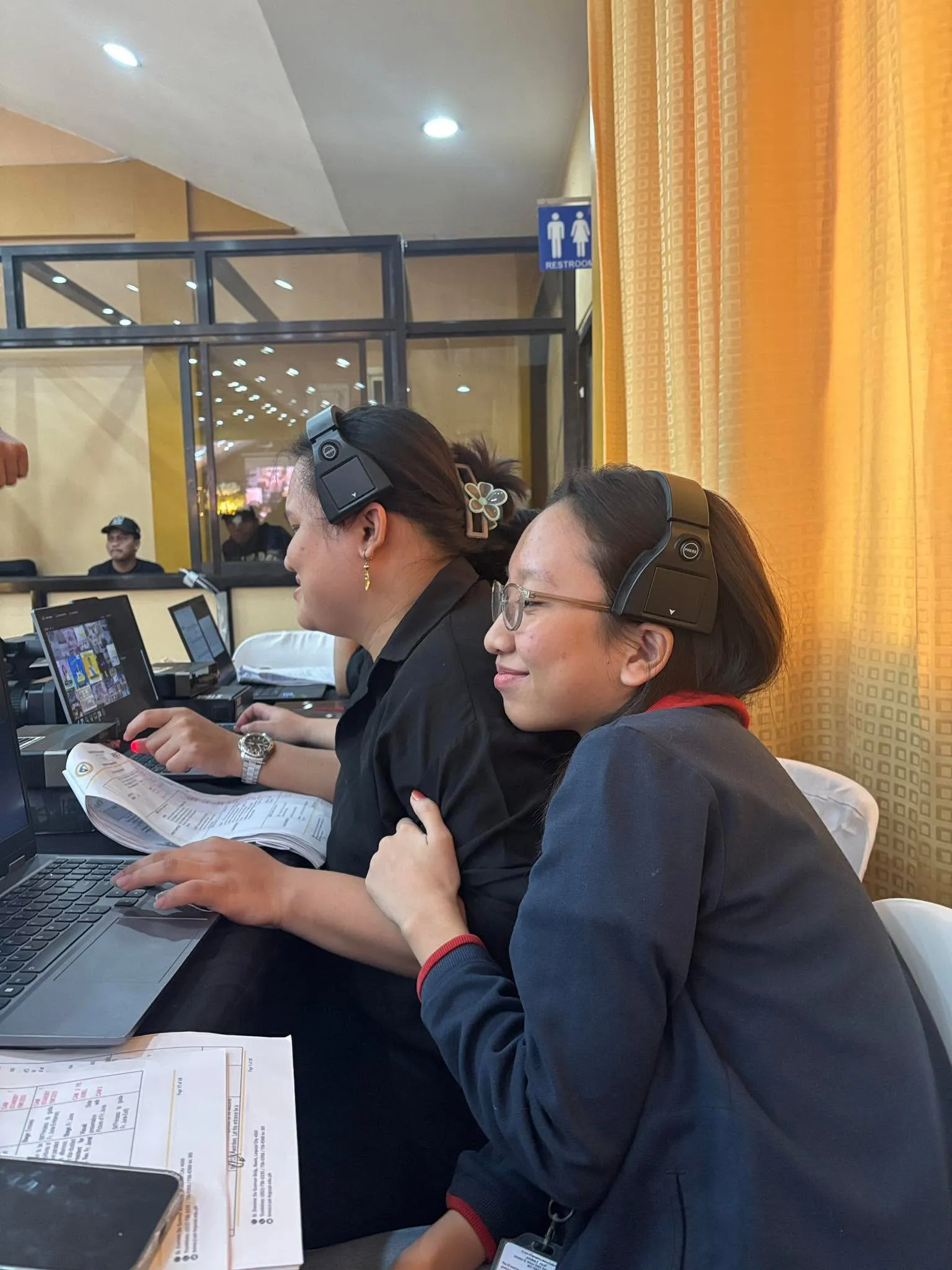 Two crew members at the switcher, one in a headset.