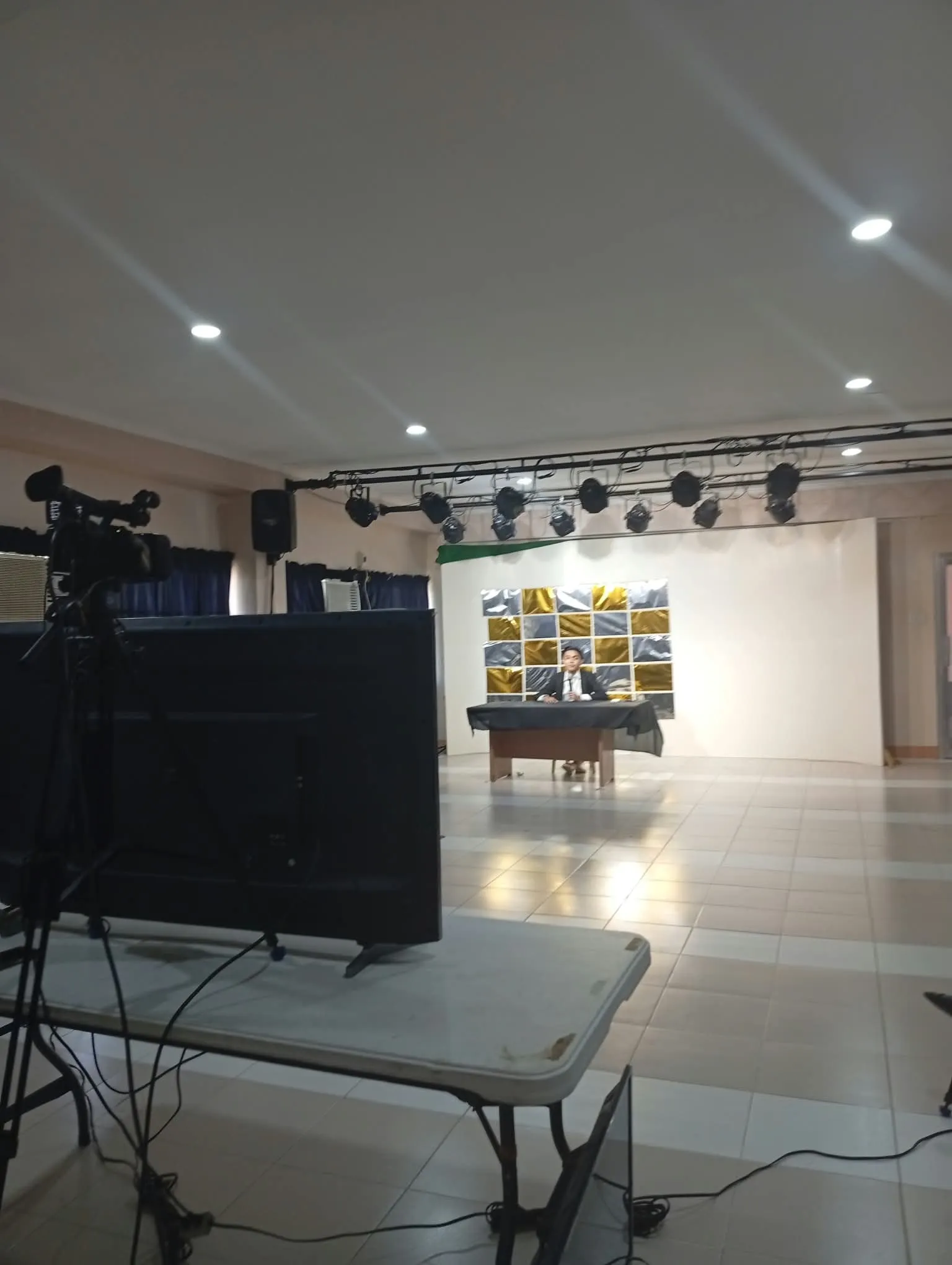 An empty set with a table and monitors, ready for a live production.