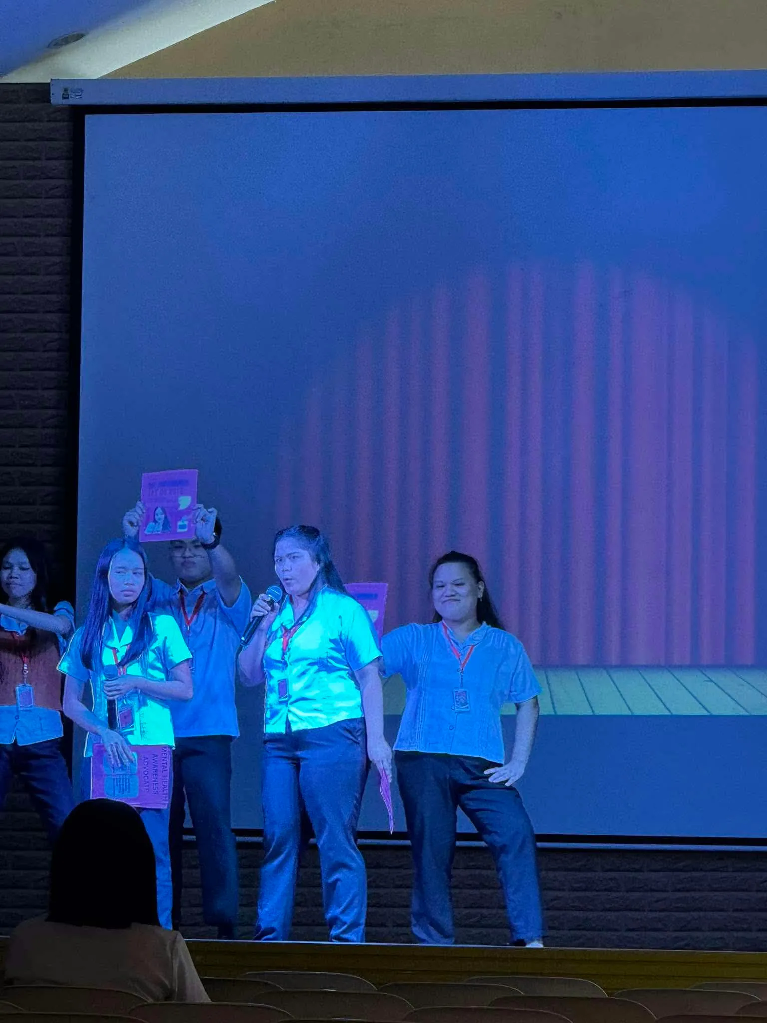 The cast performing a scene on stage.