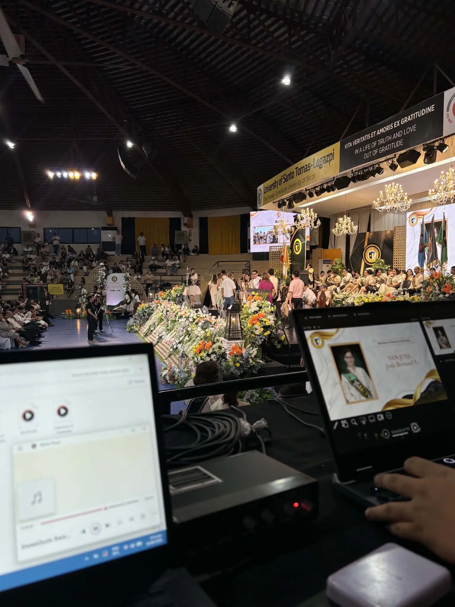 The decorated stage seen past a production laptop.