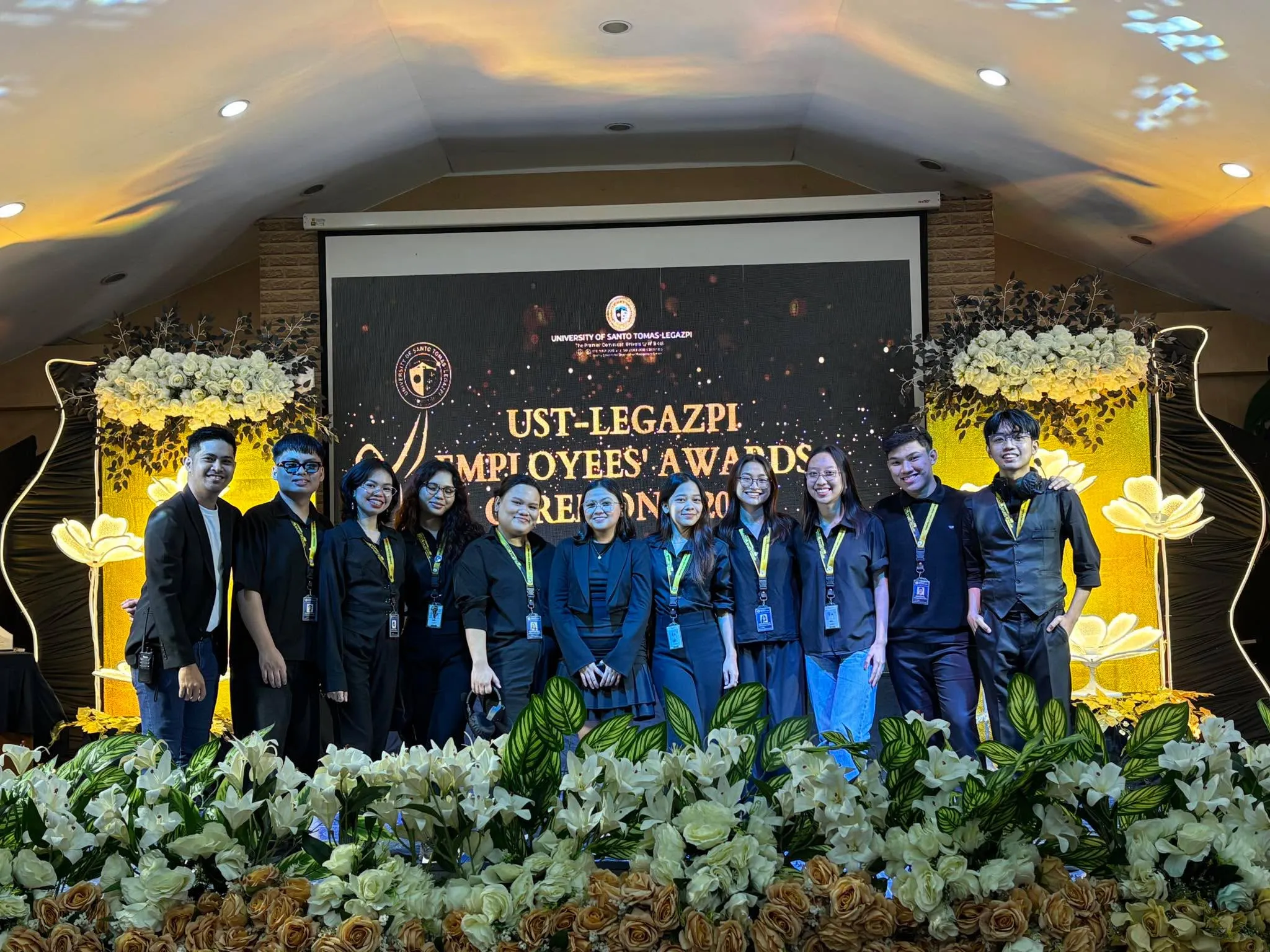 The crew posing in front of the UST-Legazpi Employees’ Awards backdrop.