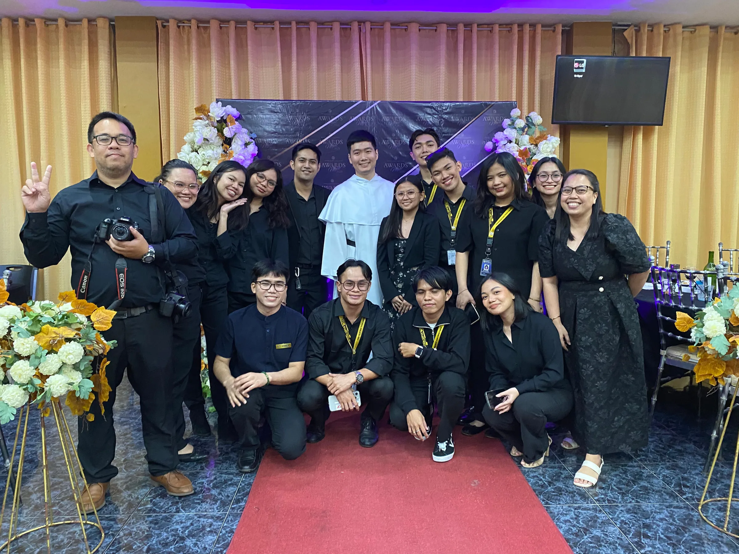 The crew posing on the red carpet at the awards night.