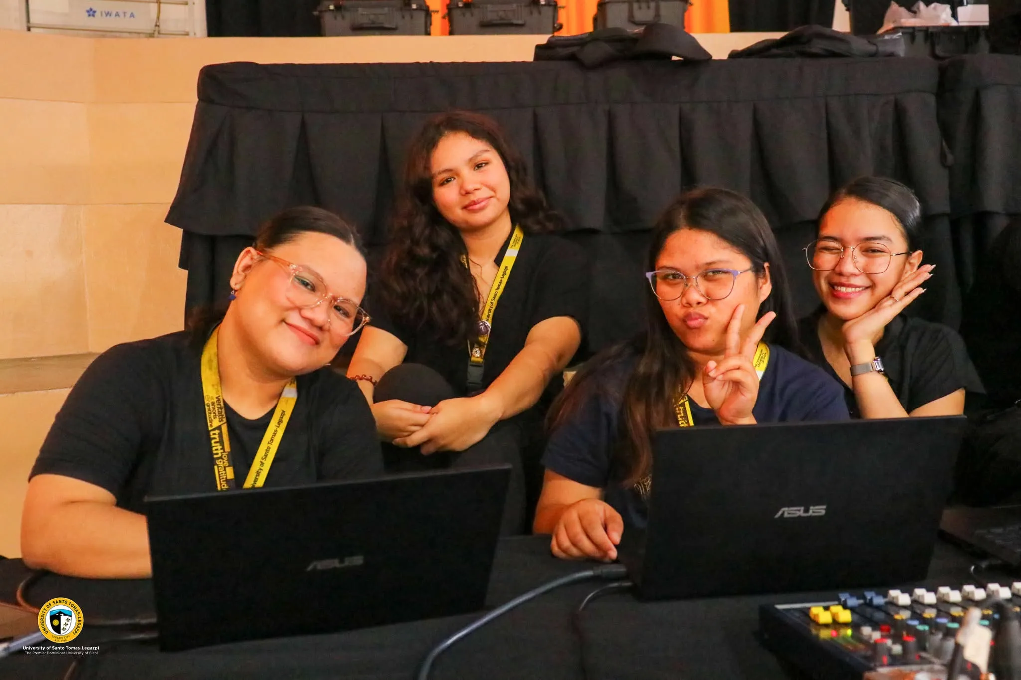 Four crew members smiling at the production desk.