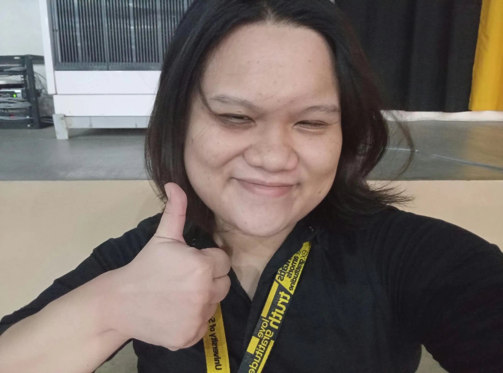 A crew member giving a thumbs-up in a selfie.
