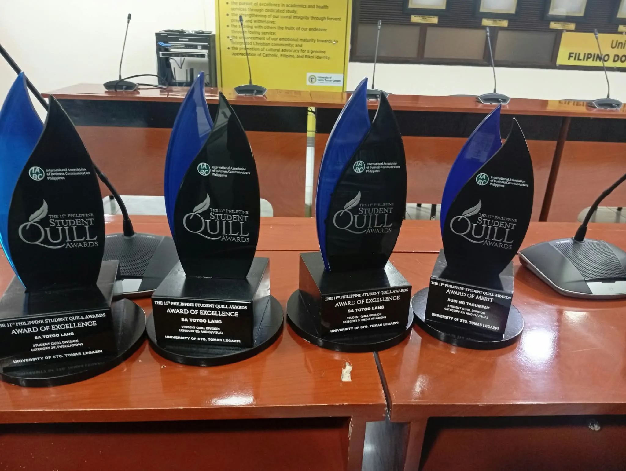 Four Quill Awards trophies on a table.