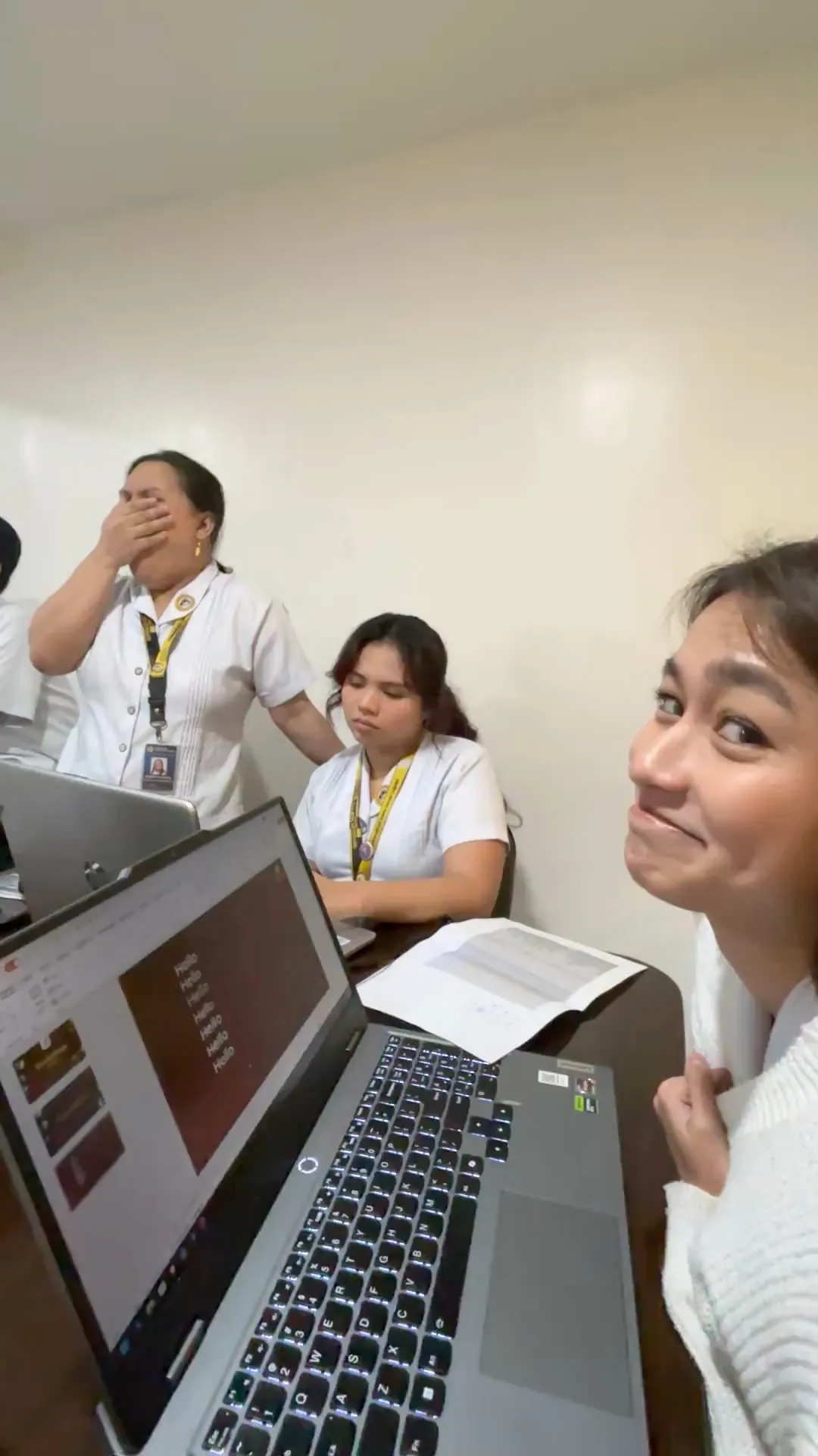 A short video of the crew at their laptops around a long table, one of them smiling at the camera.