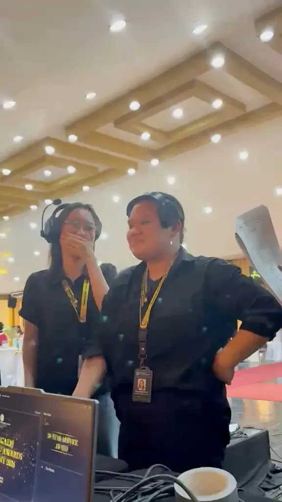 A short video of the crew in headsets at the production desk in the ballroom, laughing during the awards night.